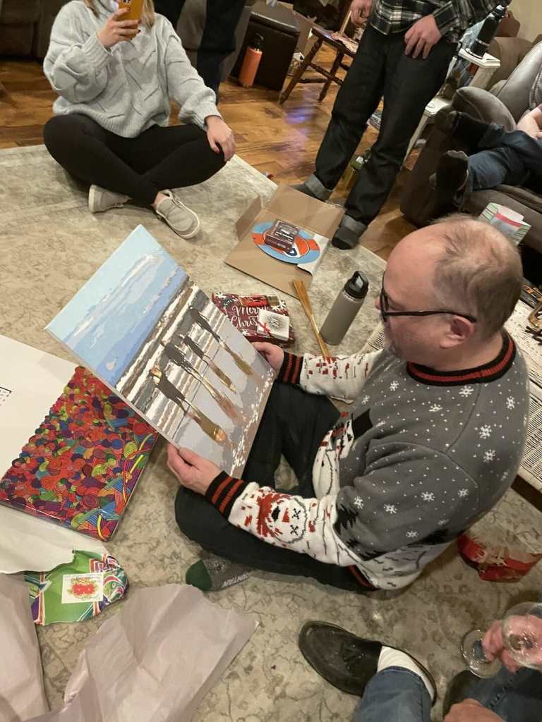 Photo of man receiving completed custom paint by numbers kit as a gift